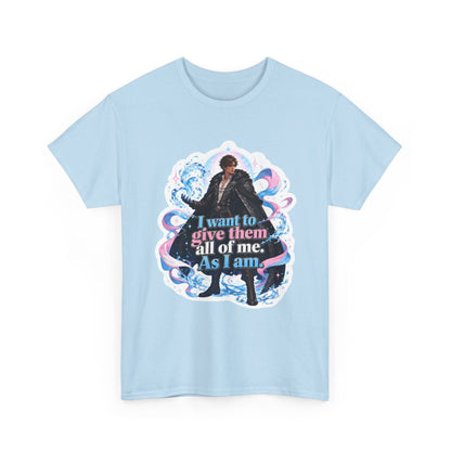 Light blue unisex t-shirt with fantasy art of a person with dark curly hair in a long black fur-trimmed coat, surrounded by swirling pink and blue ribbons of magic, and the quote "I want to give them all of me. As I am," shown flat.