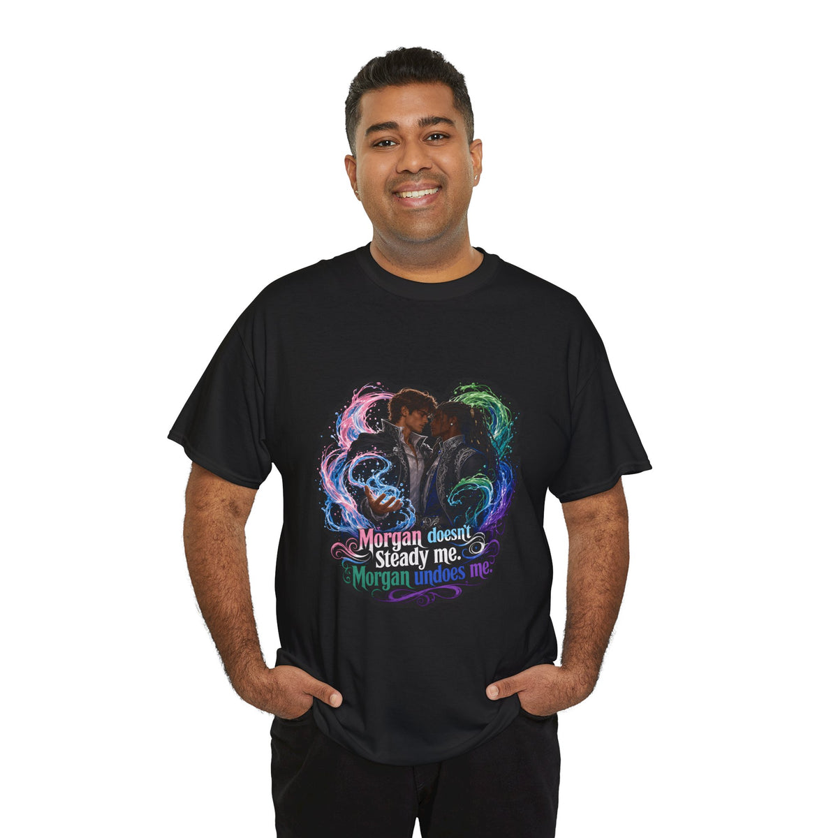 Black unisex t-shirt worn by a smiling man with short black hair and a beard, printed with fantasy art of two men embracing in swirling magic and the quote "Morgan doesn't steady me, Morgan undoes me."