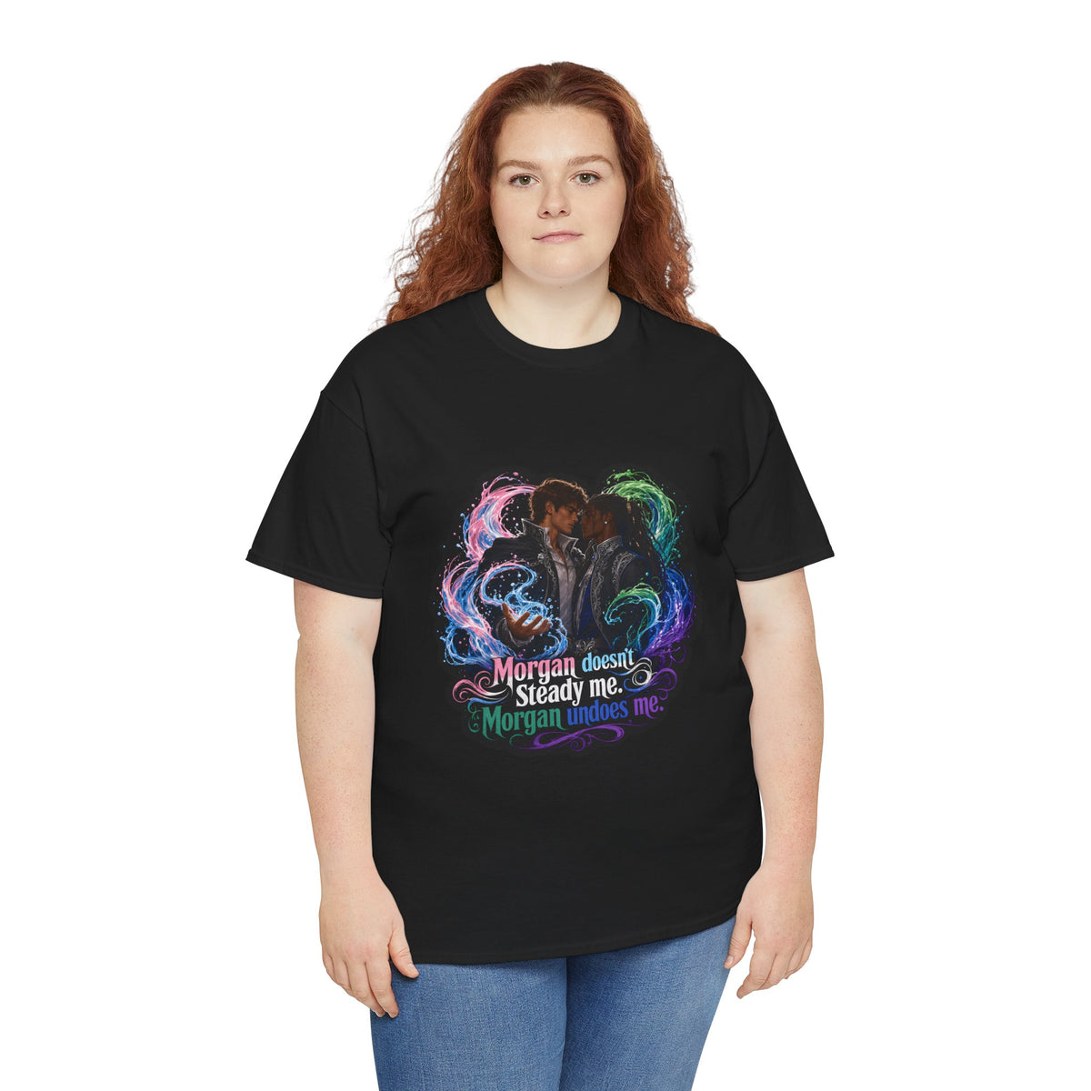 Black unisex t-shirt worn by a curvy woman with long red curly hair, printed with fantasy art of two men embracing in swirling magic and the quote "Morgan doesn't steady me, Morgan undoes me."