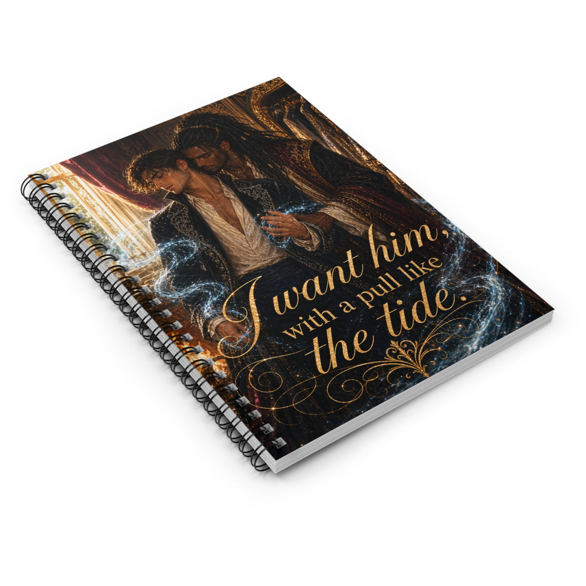 Spiral notebook lying at a three-quarter angle, romantic fantasy cover art of two men embracing in a candlelit room, gold script quote "I want him, with a pull like the tide."