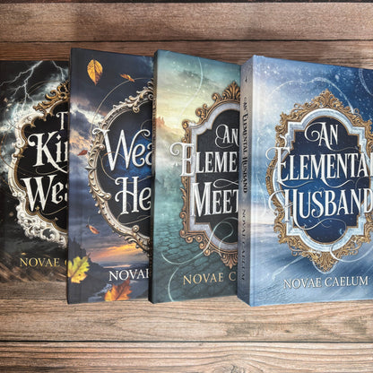 Stack of four fanned hardcover books from The King's Weaver series by Novae Caelum—The King's Weaver, A Weaver's Heart, An Elemental Meeting, and An Elemental Husband—on a wood-plank surface.