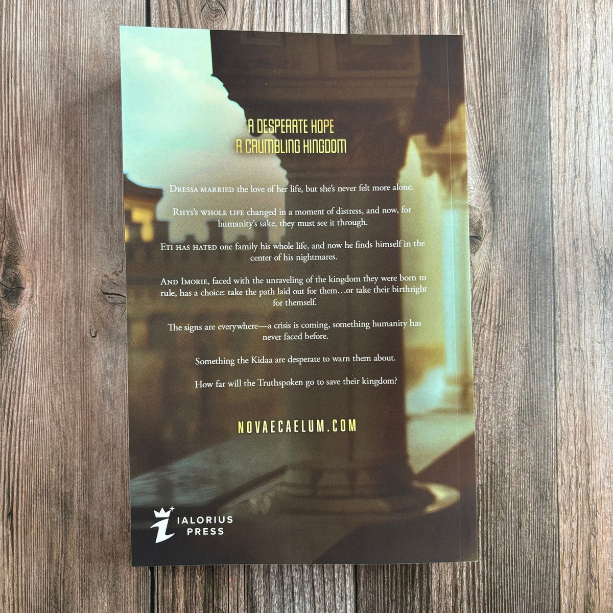 Back cover of "The Second Ruler Part Two: The Stars and Green Magics Book 7" by Novae Caelum on a wood-plank background, with synopsis text beginning "A desperate hope, a crumbling kingdom" and the Ialorius Press logo (Back Cover Paperback).