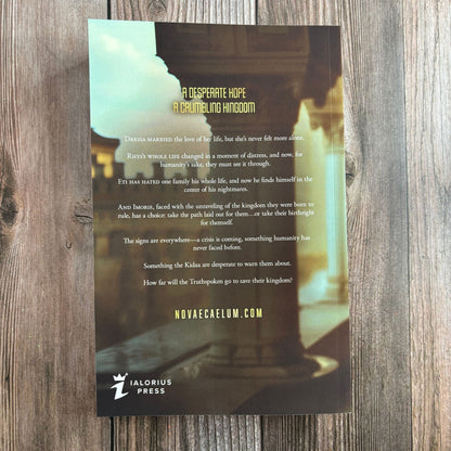 Back cover of "The Second Ruler Part Two: The Stars and Green Magics Book 7" by Novae Caelum on a wood-plank background, with synopsis text beginning "A desperate hope, a crumbling kingdom" and the Ialorius Press logo (Back Cover Paperback).